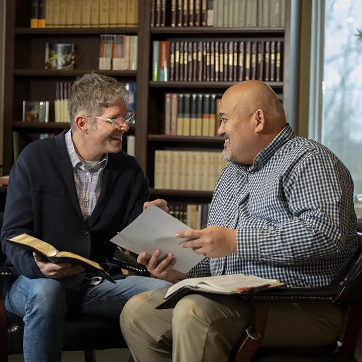 Two pastors talking and laughing